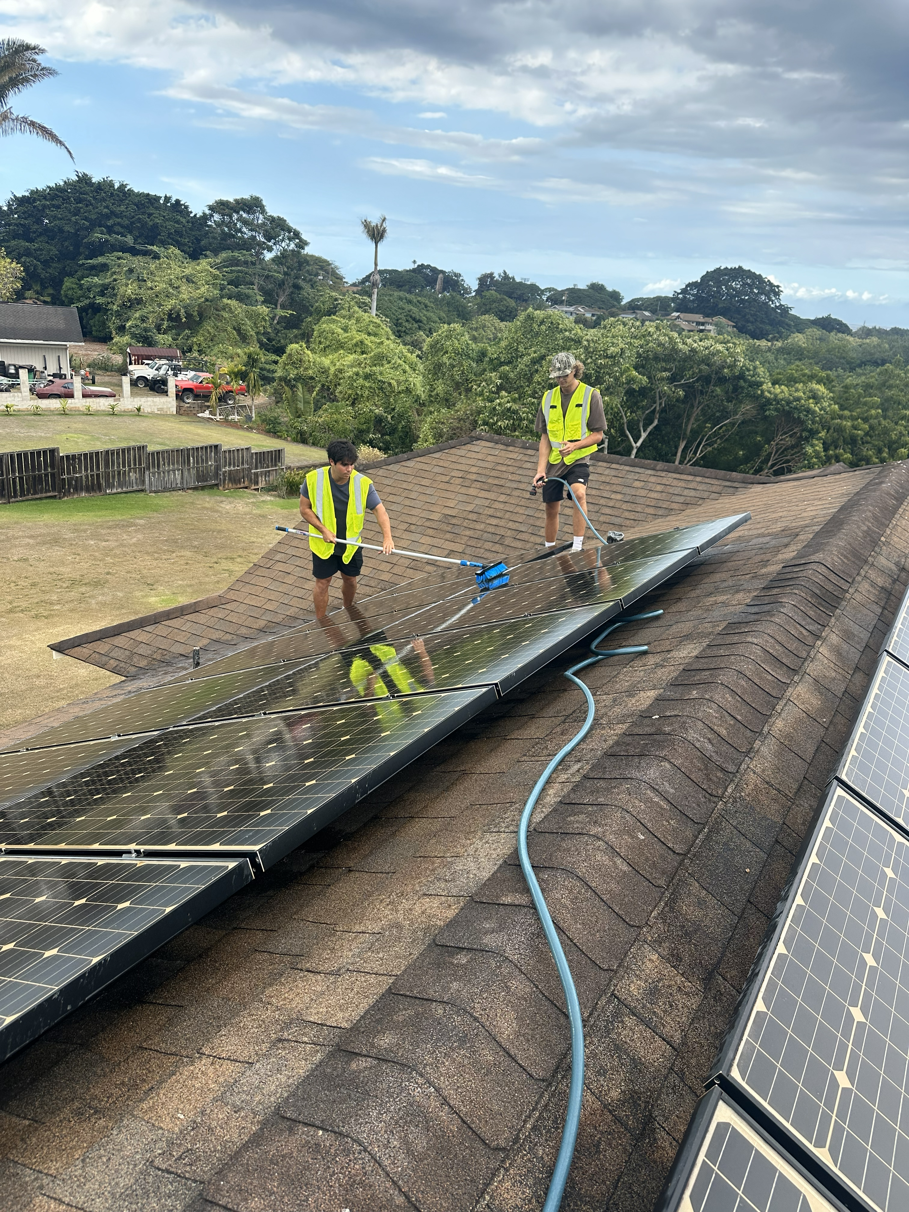 Surf's Up Solar Cleaning crew working on roof in Haleiwa